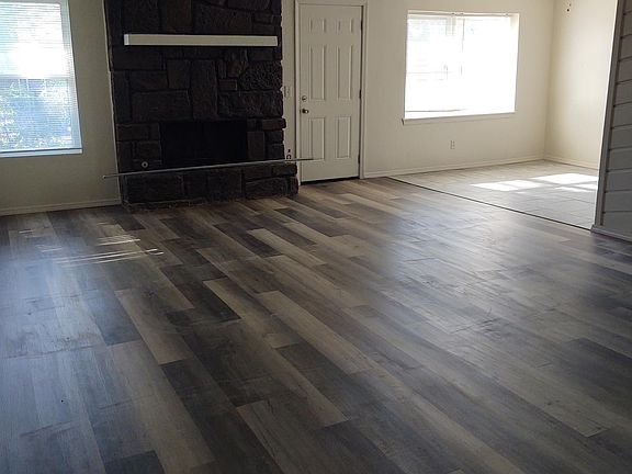 Living room with new flooring and ceiling fan