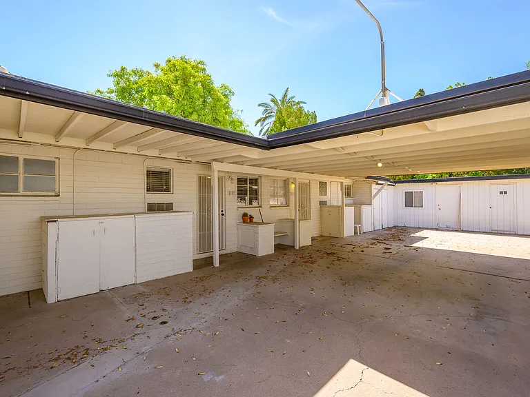 Carport, rear entry to unit and exterior laundry