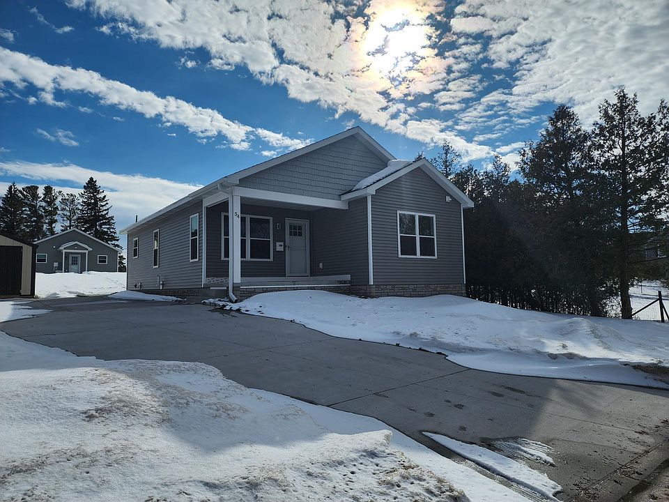 54 Fulton Street front with concrete driveway, and relaxing front porch.