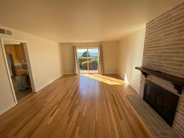Spacious Living Room with Sliding Door Leading to Backyard Patio