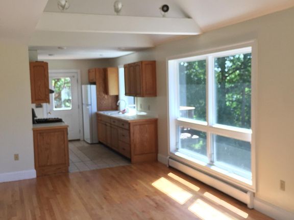 View from living area through dining area on into the kitchen.