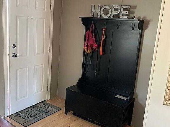 Coat closet behind mirror 