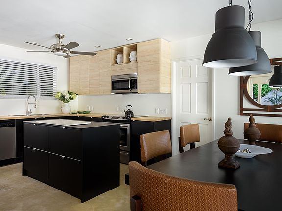 New birch kitchen cabinets and matte black lower cabinets. Butcher block counters