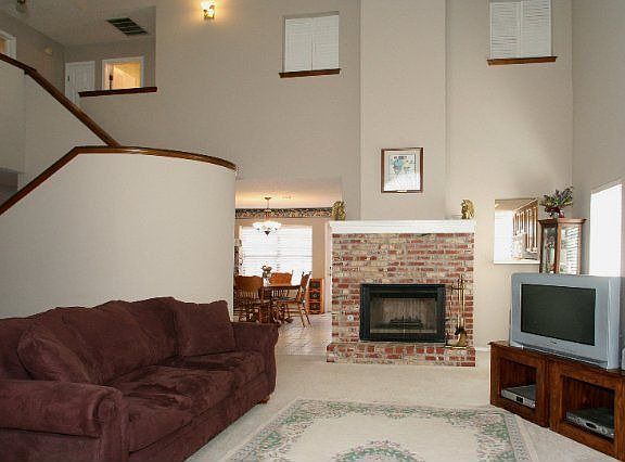 Living Room with Curved Staircase & Fireplace