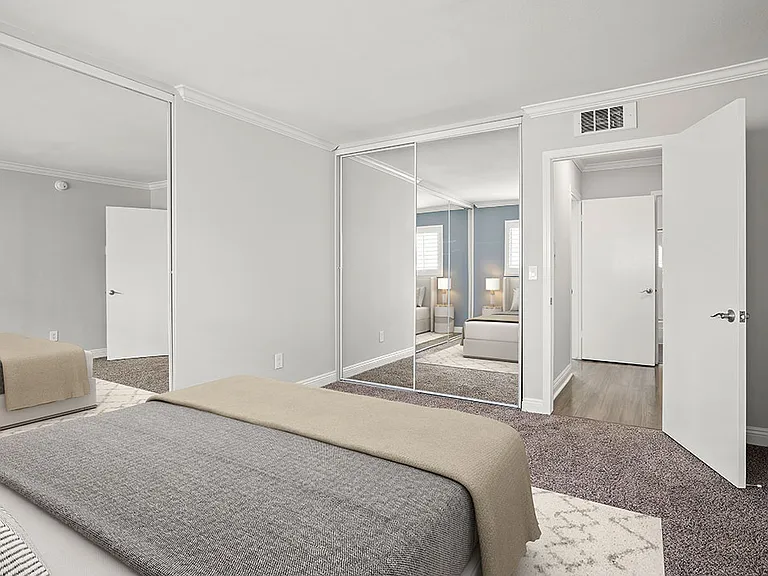 Carpeted bedroom with copious closet space.