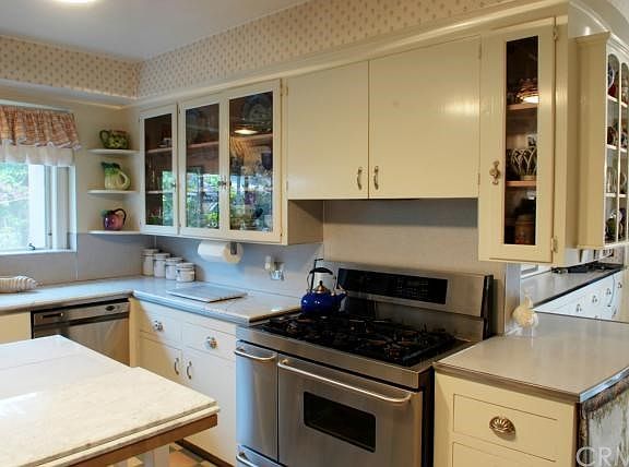Marble Counters & Island; Stainless Steel Appliances & Sink; Views to Side Yard.