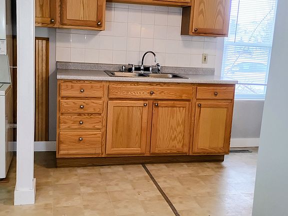Kitchen Cabinets complimented with beautiful tile, so easy to clean!