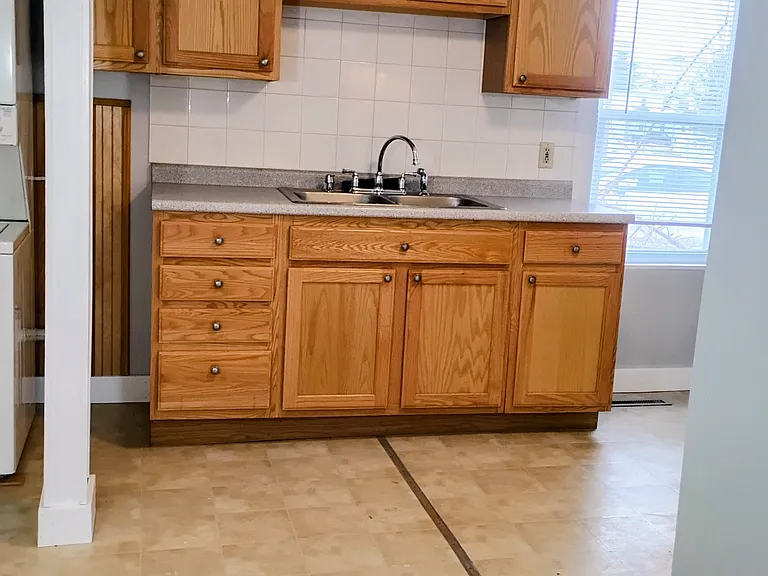 Kitchen Cabinets complimented with beautiful tile, so easy to clean!
