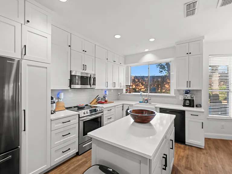 Clean, welcoming kitchen with modern appliances and plenty of counter space.