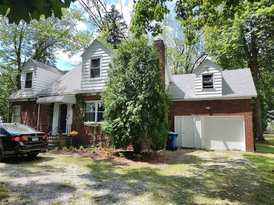 Front with large single car garage and parking in front of the home