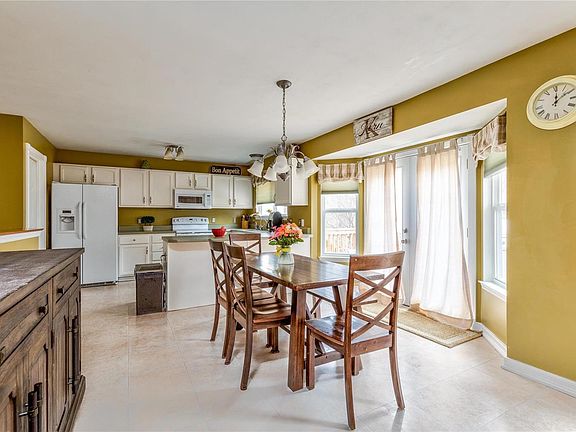Large, open kitchen with open floor plan.  French doors leading to deck where you can BBQ in privacy with the backyard backing t