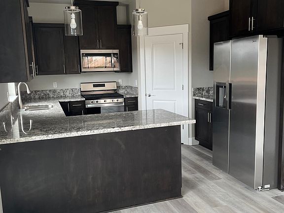 Kitchen with stainless steel appliances. Refrigerator has ice maker. Large walk-in pantry.