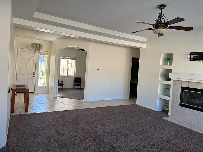 Living room with view of office and entrance