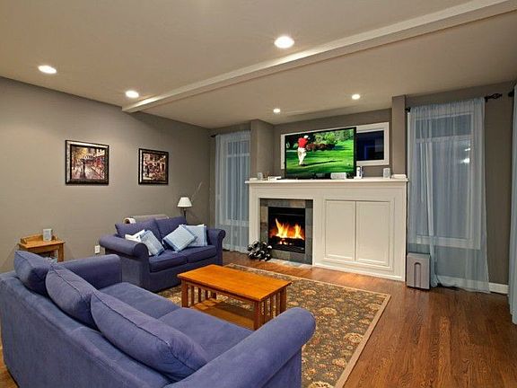 Kitchen & Dining room opens into a cozy Family room with espresso finished hardwood floors, custom shelves & draperies, designer paint.