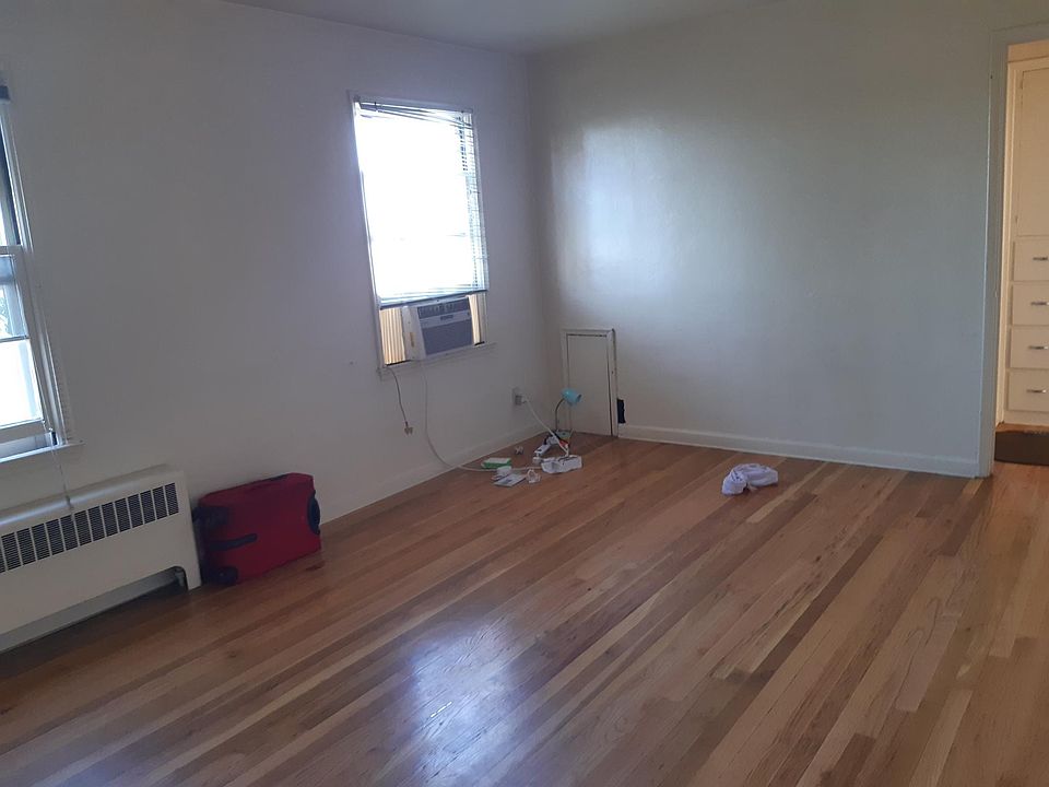 Living room with A/C window unit and heater