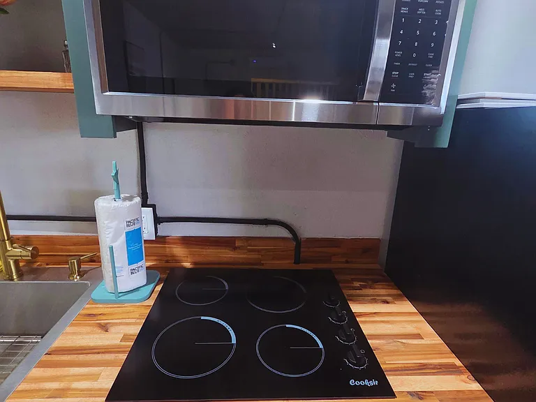Fully equipped with a ceramic stove and microwave for effortless cooking.