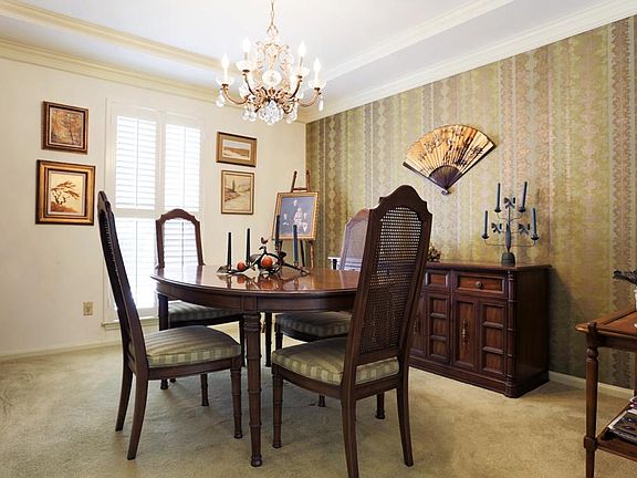  Lovely molding with recent windows, paint and plantation shutters is 12 ' x 11'. Opens to front hall and kitchen. Beautiful crystal chandelier included.