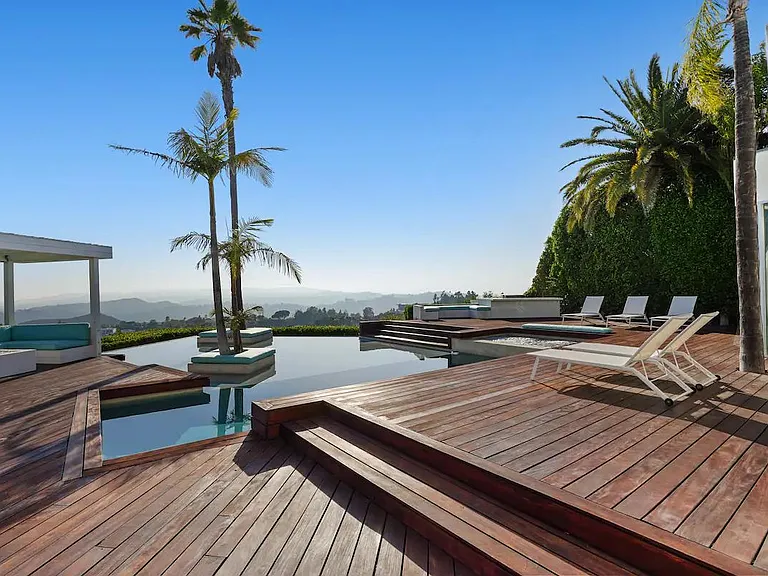 Savor sweeping views of the surrounding landscape from the outdoor deck, providing a breathtaking backdrop for relaxation.