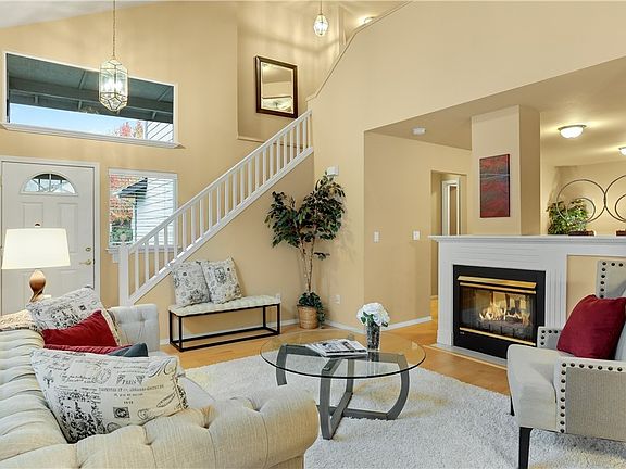 You are going to fall in love with the dramatic, two-story vaulted ceiling in the formal living room. Timeless wood balusters that pass through light from the second level. 