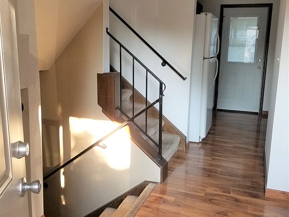 From the front entrance looking toward the kitchen and back door, including stairs.