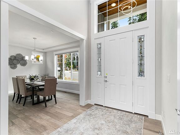 Elegant foyer with custom chandelier. Front door opens to the east.