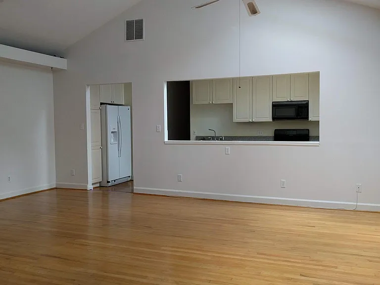 Large living - dining area with cathedral ceiling and skylig