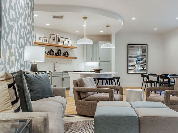 Modern Clubroom Featuring Kitchen, Lounge Chairs, and Dining Area