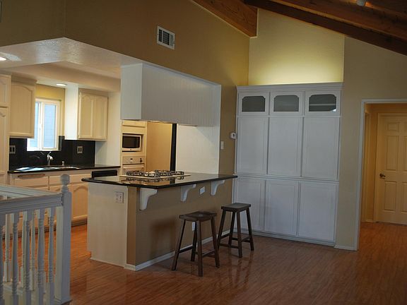 Kitchen-Dining with cabinetry and bar seating.
