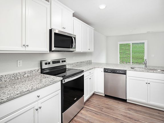 Stainless steel appliances are included in the kitchen