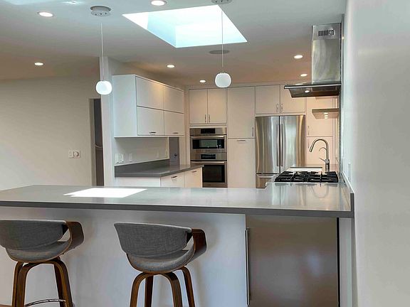 Bar / serving area with wine refrigerator below