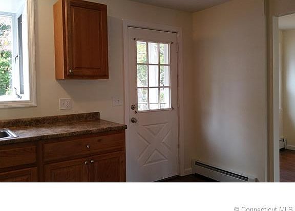 Kitchen door leads to large...