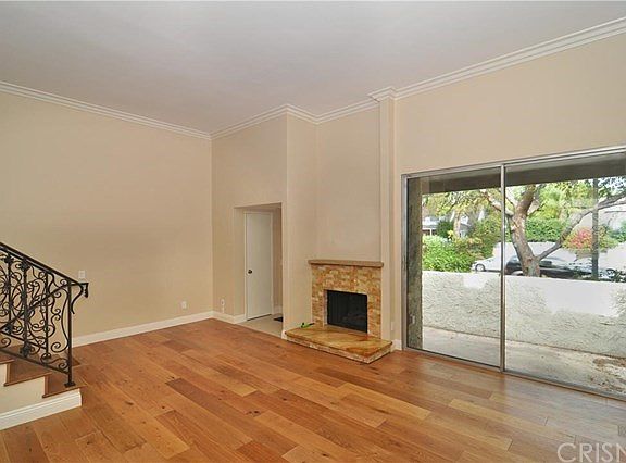Living room with view of patio area and fireplace