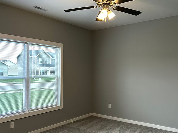 Master bedroom freshly carpeted, ceiling fan with a walk in closet and a walk in bathroom!