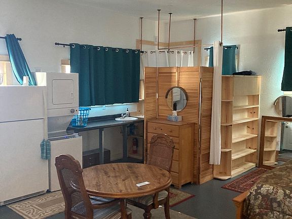 To the left is the bathroom, and "laundry room" area next photo shows the bathroom behind the wooden door