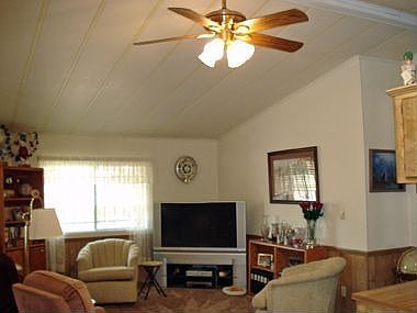 Great room offers lots of options. Ceiling fans and custom drapes throughout.