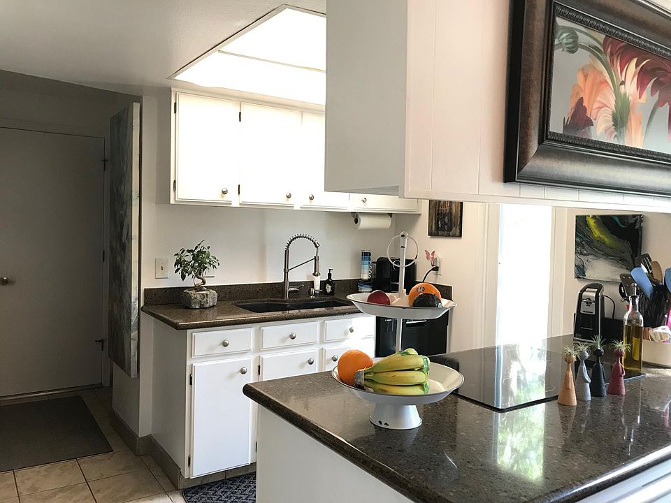 Wonderful lighting in the kitchen with granite countertops, ceramic glass top stove, built in range (self-cleaning) and microwave, and large refrigerator with ice maker.