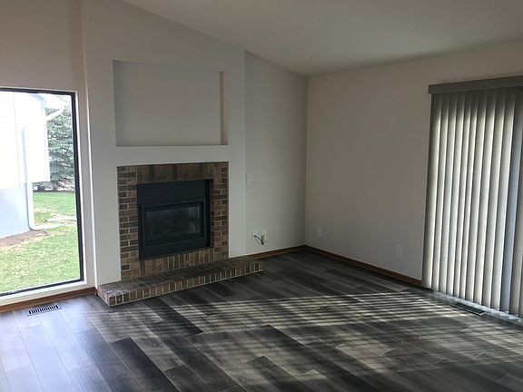 Family room. Gas fireplace. Vinyl plank flooring.
