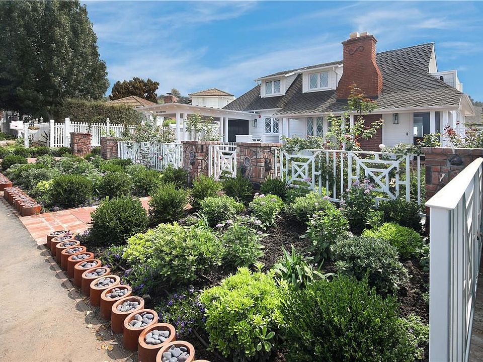 Custom landscape and stonework create beautiful curb appeal and a lovely place to spend the afternoon.