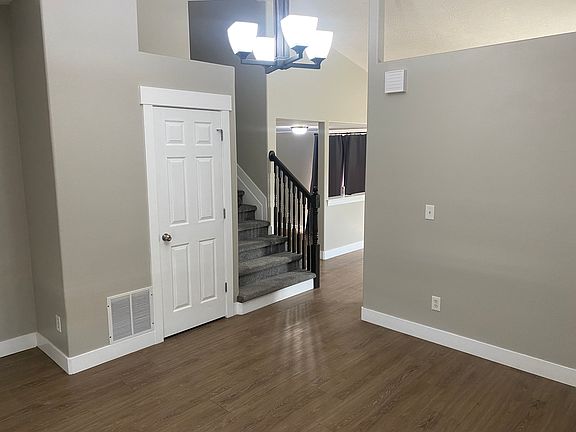 Entrance room, with stairs leading to the top floor and entrance to kitchen
