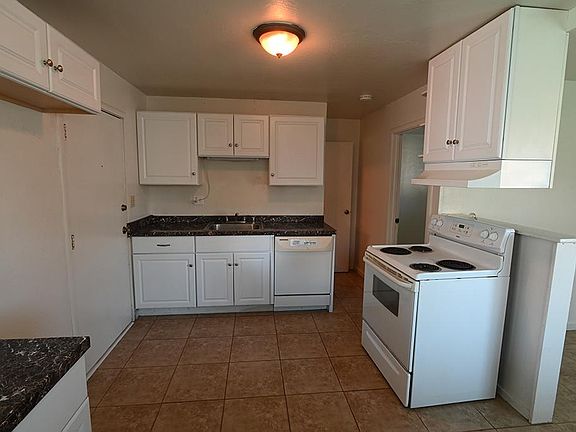 Kitchen area with plenty of cabinets. Additional cabinet /counter in bottom left of photo.