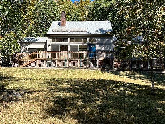 Front view of house. The house sits on a hill sit this is halfway up the front yard looking up.