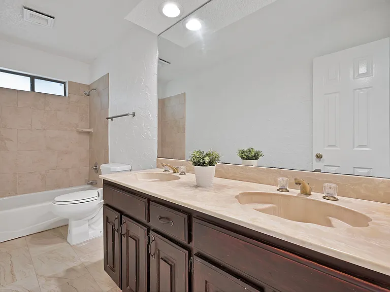 Upstairs bathroom double sink and tub shower combination.