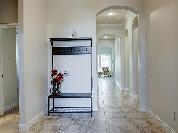 Entry foyer with two secondary bedrooms and bathroom on left. Living areas ahead.