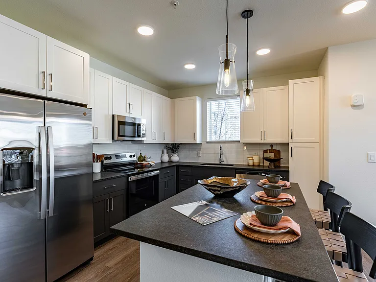 Modern kitchen with stainless steel appliances.