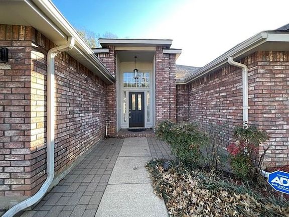 Property entrance with a patio area