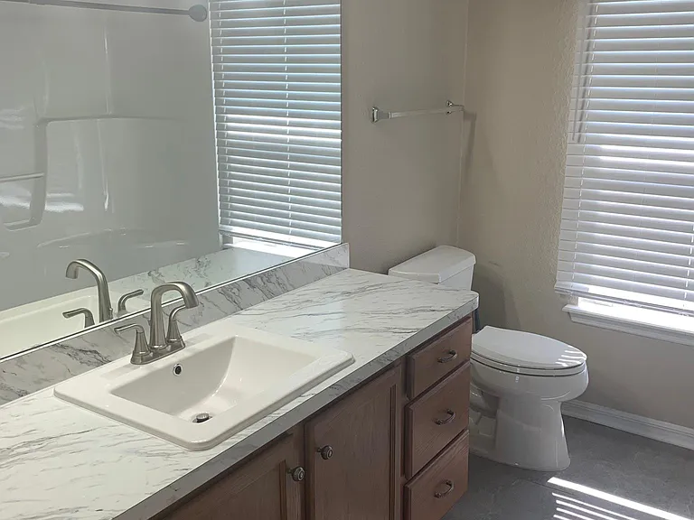 Master bath with new paint, counter tops and flooring.