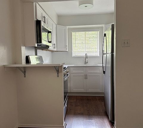 Kitchen with Quartz countertops, Stainless Steel appliances, and new Cabinets