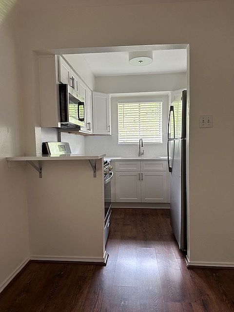 Kitchen with Quartz countertops, Stainless Steel appliances, and new Cabinets