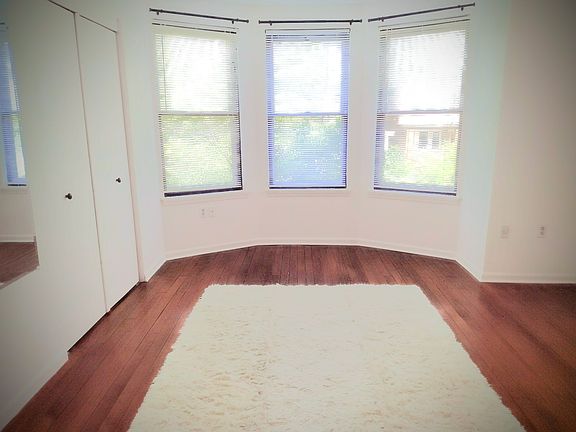 Master bedroom with bay window and large alcove for king size bed, his and her closets running full length of the bedroom, long mirror installed for convenience and utility. Bedroom overlooks spectacular dogwood tree. Original heart pine floors.
