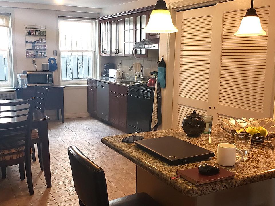 Kitchen with Granite Island and Stainless Steel Dishwasher